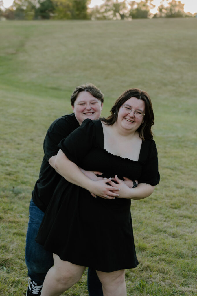 Couple embracing in front of rolling hills at Cuyahoga Valley National Park